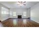 Spacious living room featuring hardwood flooring, neutral walls, ceiling fan and fireplace at 5011 Wewatta Sw St, Atlanta, GA 30331