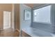 Bathroom featuring a modern tub under a bright window and separate door to shower at 597 River Gardens Dr, Atlanta, GA 30354