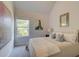 Bedroom featuring large windows, a bed with decorative pillows and artwork at 597 River Gardens Dr, Atlanta, GA 30354