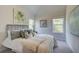 Bedroom featuring large windows, a bed with decorative pillows and artwork at 597 River Gardens Dr, Atlanta, GA 30354