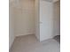 Well-organized walk-in closet featuring shelving, carpeted floors, and convenient door access at 597 River Gardens Dr, Atlanta, GA 30354