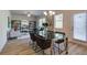 Dining area with contemporary table and chairs, wood-look flooring, and modern light fixture at 597 River Gardens Dr, Atlanta, GA 30354