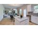 Open-concept floor plan with island featuring granite countertops, modern appliances, and wood-look flooring at 597 River Gardens Dr, Atlanta, GA 30354