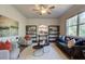 Spacious living room with neutral walls, stylish furniture, ceiling fan, and bright natural lighting at 597 River Gardens Dr, Atlanta, GA 30354