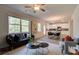 Living room with kitchen in background featuring hardwood floors, open windows, and neutral walls at 597 River Gardens Dr, Atlanta, GA 30354
