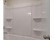 Bright tub and shower combo with built-in shelving at 597 River Gardens Dr, Atlanta, GA 30354