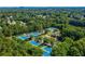 Aerial view of a community featuring tennis courts, a swimming pool, and lush green trees at 12370 Preserve Ln, Johns Creek, GA 30005