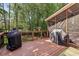 Spacious back deck with grilling area and view of the wooded backyard and screened porch at 12370 Preserve Ln, Johns Creek, GA 30005