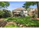 Spacious backyard featuring a well-maintained lawn, a patio area, and mature trees at 12370 Preserve Ln, Johns Creek, GA 30005