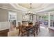 Elegant dining room features an ornate ceiling, access to the screened porch, and hardwood floors at 12370 Preserve Ln, Johns Creek, GA 30005