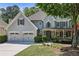 Charming two-story home with a well-manicured lawn and a three-car garage at 12370 Preserve Ln, Johns Creek, GA 30005