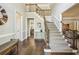 Grand foyer with hardwood floors, staircase, and views into the living spaces at 12370 Preserve Ln, Johns Creek, GA 30005
