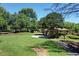 Lush green space with mature trees, a covered picnic pavilion, and walking path is perfect for outdoor activities at 12370 Preserve Ln, Johns Creek, GA 30005