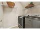 Laundry room with modern washer and dryer, and wire shelving for storage at 12370 Preserve Ln, Johns Creek, GA 30005