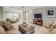 Living room featuring a large sofa, TV, and light gray walls at 12370 Preserve Ln, Johns Creek, GA 30005