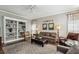 Cozy living room features a built-in bookshelf, a ceiling fan and neutral decor at 12370 Preserve Ln, Johns Creek, GA 30005