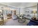 Elegant living room with plush seating, decorative accents, and views into the dining area at 12370 Preserve Ln, Johns Creek, GA 30005