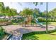 Community playground with slides, climbing structures, and a wood chip ground cover at 12370 Preserve Ln, Johns Creek, GA 30005