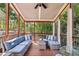 Relaxing screened-in porch with comfortable seating and views of the surrounding greenery at 12370 Preserve Ln, Johns Creek, GA 30005