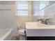 Bright bathroom with tile surround tub, window, and single sink vanity at 2345 Leith Ave, Atlanta, GA 30344