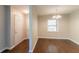 Open concept dining room with hardwood flooring offers a modern chandelier fixture and natural lighting at 2345 Leith Ave, Atlanta, GA 30344