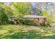 Charming brick home with a well-maintained front lawn and mature trees offers great curb appeal at 2345 Leith Ave, Atlanta, GA 30344