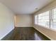 Bright living room with polished hardwood floors has large windows overlooking the picturesque neighborhood at 2345 Leith Ave, Atlanta, GA 30344