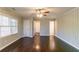 Spacious living room featuring hardwood floors, a ceiling fan, and natural light through large windows at 2345 Leith Ave, Atlanta, GA 30344