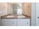 Bathroom featuring a double sink vanity with granite counters and a large mirror at 3568 Oakshire Se Way, Atlanta, GA 30354