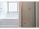 Bathroom featuring a separate shower and tub beneath a window with blinds at 3568 Oakshire Se Way, Atlanta, GA 30354