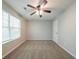 Bright bedroom featuring neutral tones, a ceiling fan, and a window with blinds at 3568 Oakshire Se Way, Atlanta, GA 30354