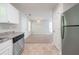 Well-lit kitchen with stainless steel dishwasher, ample cabinet space, and neutral countertops at 3568 Oakshire Se Way, Atlanta, GA 30354