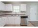 Well-lit kitchen with stainless steel dishwasher, ample cabinet space, and neutral countertops at 3568 Oakshire Se Way, Atlanta, GA 30354