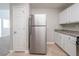 Well-lit kitchen with stainless steel refrigerator, ample cabinet space, and neutral countertops at 3568 Oakshire Se Way, Atlanta, GA 30354