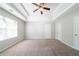 Spacious main bedroom with a tray ceiling, a ceiling fan, and abundant natural light at 3568 Oakshire Se Way, Atlanta, GA 30354