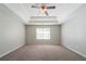 Spacious main bedroom with a tray ceiling, a ceiling fan, and abundant natural light at 3568 Oakshire Se Way, Atlanta, GA 30354
