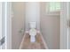 Powder room featuring a standard toilet, tile flooring, and a window at 3568 Oakshire Se Way, Atlanta, GA 30354