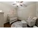 A Bedroom/bedroom features light-toned furniture, a plush chair, and a decorative mural at 4265 Prince Charles Dr, Duluth, GA 30097