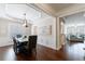 Open-concept dining area with hardwood floors, chandelier, and seamless flow to living spaces at 4265 Prince Charles Dr, Duluth, GA 30097