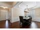 Elegant dining room with tray ceiling, chandelier, hardwood floors, and natural light at 4265 Prince Charles Dr, Duluth, GA 30097