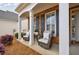 Cozy front porch features comfortable seating and charming decor, perfect for relaxing at 4265 Prince Charles Dr, Duluth, GA 30097