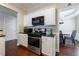 Kitchen with stainless steel oven, gas range, white cabinets, and hardwood floors at 4265 Prince Charles Dr, Duluth, GA 30097