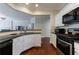 Well-lit kitchen featuring stainless steel appliances, dark countertops, and seamless flow to other living spaces at 4265 Prince Charles Dr, Duluth, GA 30097