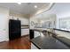 Modern kitchen with granite countertops, stainless steel sink, and black appliances at 4265 Prince Charles Dr, Duluth, GA 30097