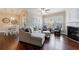 Sunlit living room featuring a fireplace, sectional sofa, hardwood floors, and neutral decor at 4265 Prince Charles Dr, Duluth, GA 30097
