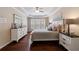 A traditionally decorated main bedroom features tray ceilings, plantation shutters, and stylish furnishings at 4265 Prince Charles Dr, Duluth, GA 30097
