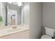 Modern bathroom with neutral walls, mirror, and white vanity for a serene atmosphere at 745 Abbotts Mill Ct, Johns Creek, GA 30097