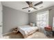 Comfortable bedroom featuring natural light, ceiling fan, and neutral walls for a calming space at 745 Abbotts Mill Ct, Johns Creek, GA 30097