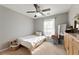 Bright bedroom with ceiling fan, natural light, and neutral walls for a serene atmosphere at 745 Abbotts Mill Ct, Johns Creek, GA 30097