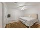 Cozy bedroom with a tufted headboard, ceiling fan, and a decorative rug at 745 Abbotts Mill Ct, Johns Creek, GA 30097